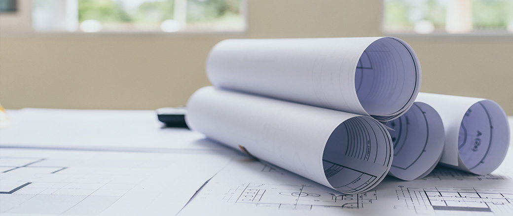 Rolled up blueprints on a table